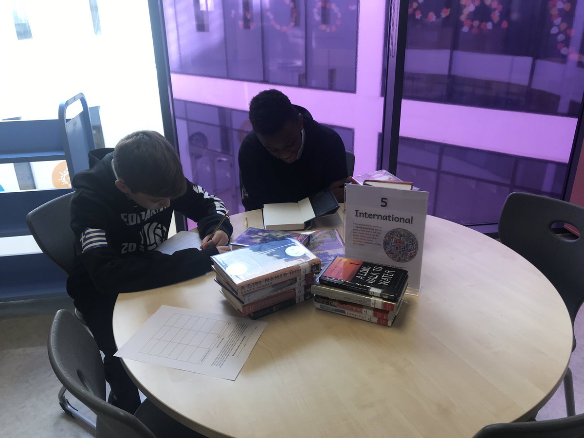 Mgintaut's tweet image. Grade 7 in for book tasting. Exploring genres related to the 40 Book Challenge. @DaaMiddle @GEMSLibNetwork @gems_daa #40bookchallenge #mslibrary