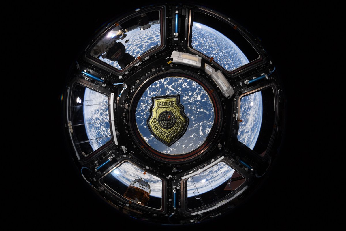 WeaponsSchool's tweet photo. "About a year ago, #AFSPC/ #A3T had the idea of seeing if Col Nick Hague (USAF flight test engineer, NASA astronaut) could take the #328WPS WIC coin to space (and some other 328WPS swag) during his latest NASA mission as part of the #Expedition60 crew. https://t.co/cPvE5TtIMU