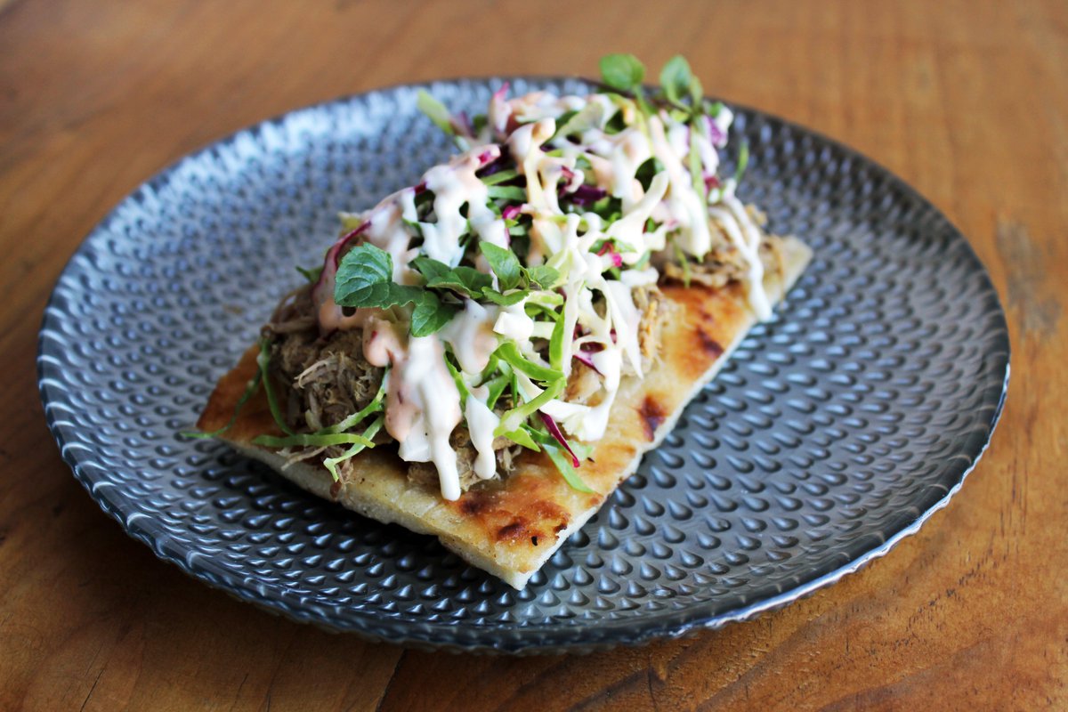 A delicious seasonal starter you can now enjoy at The Cottage: slow-cooked spiced Gorvagh goat, flatbread, garden cabbage slaw, mint and garlic aïoli. 😋