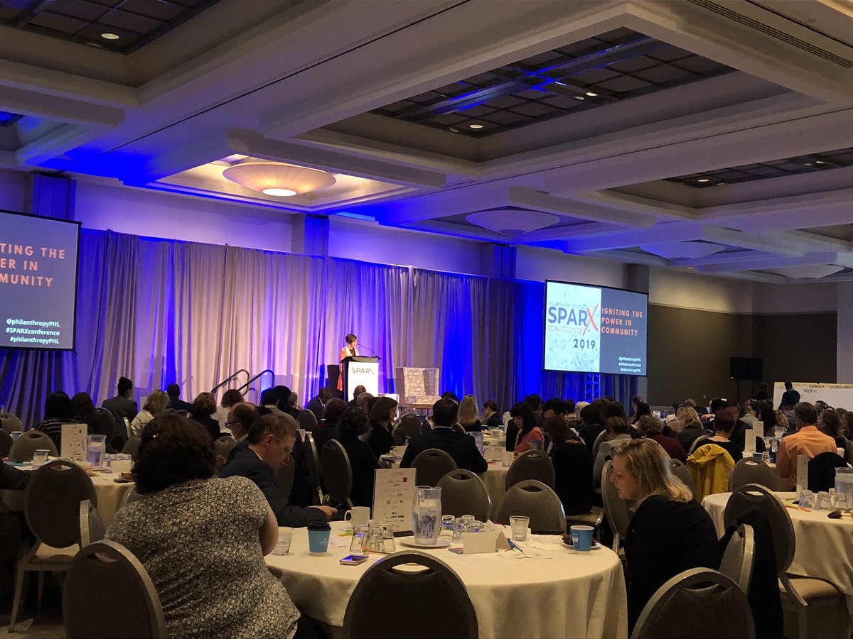 philanthropyPHL's tweet photo. Lights. Camera. Action!  #SPARXconference is officially underway! Board Chair @JenniferPedroni welcoming a record-setting crowd of 400+ for Igniting the Power in Community. https://t.co/S5Jx4Zhxo3