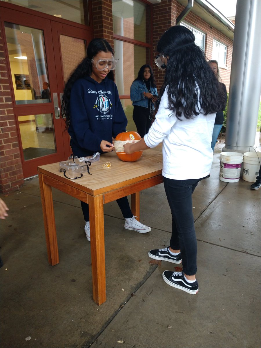 JCRmathmama's tweet photo. There are no tricks at Glenn HS today. Ms Franklin-Reese and Ms Neil are facilitating student exploration of the diameter of a pumpkin vs the number of rubber bands needed for pumpkin explosion! #wsfcsmath @VMSTheMathLady https://t.co/rXlR6ZGnNR