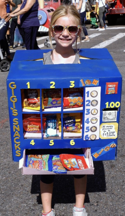 SU2C's tweet photo. Happy #Halloween from SU2C! This year, 8-year-old Gianna dressed up as a working ‘vending machine’ and donated all proceeds to #StandUpToCancer. We are honored to be her beneficiary for this costume, and we Stand Up for all kids fighting #cancer alongside Gianna! ❤ https://t.co/VGGqPrQnyQ