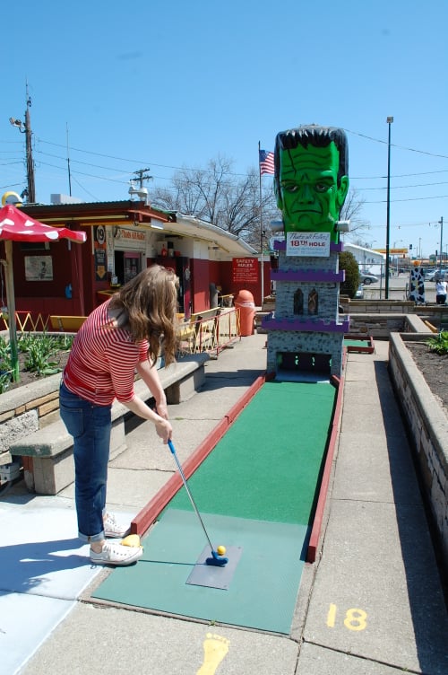 CouplePutts's tweet photo. Puttober Day 31 - Our friend Ursula playing the final hole featuring Frankenstein at Novelty Golf outside Chicago. Review at https://t.co/x2I5ZxvH9q 
Happy Halloween and Thanks for following along with us this year!  Have fun today! #puttober #minigolf https://t.co/2256uLKcj4