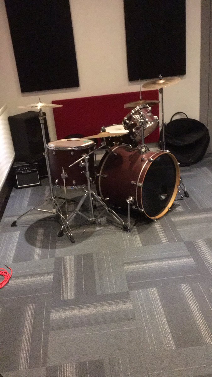 In the practice room waiting for the rest of the band