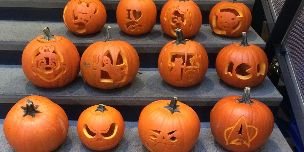 Three rows of carved jack-o-lanterns on a stairwell