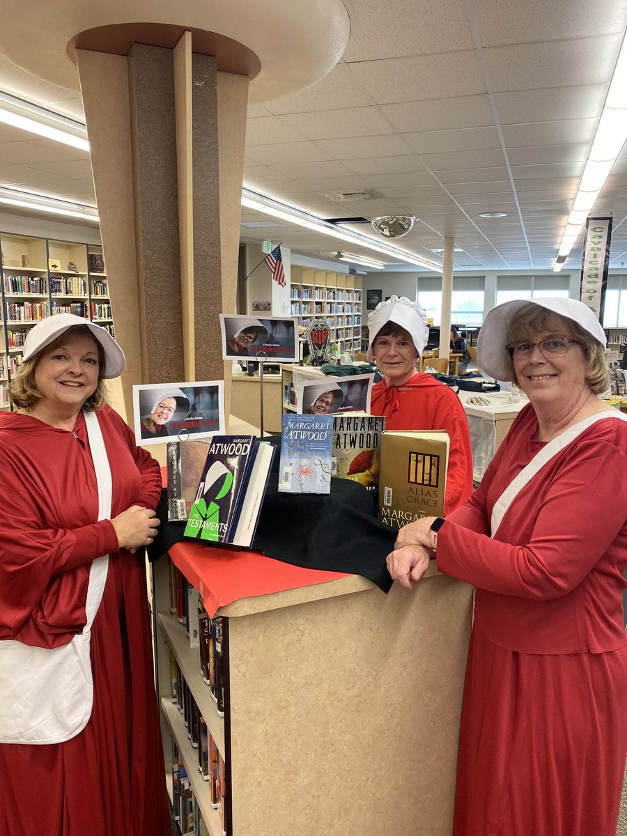 RDartnall's tweet photo. Halloween at RHS Library - honoring Margaret Atwood and all things Handmaid’s Tale #RHSteach #halloween2019 #RHSHallowern https://t.co/4VP6Uz5s40