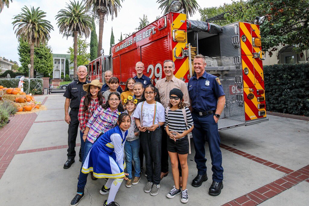Mayor Garcetti with kids in costume and LAFD firefighters.