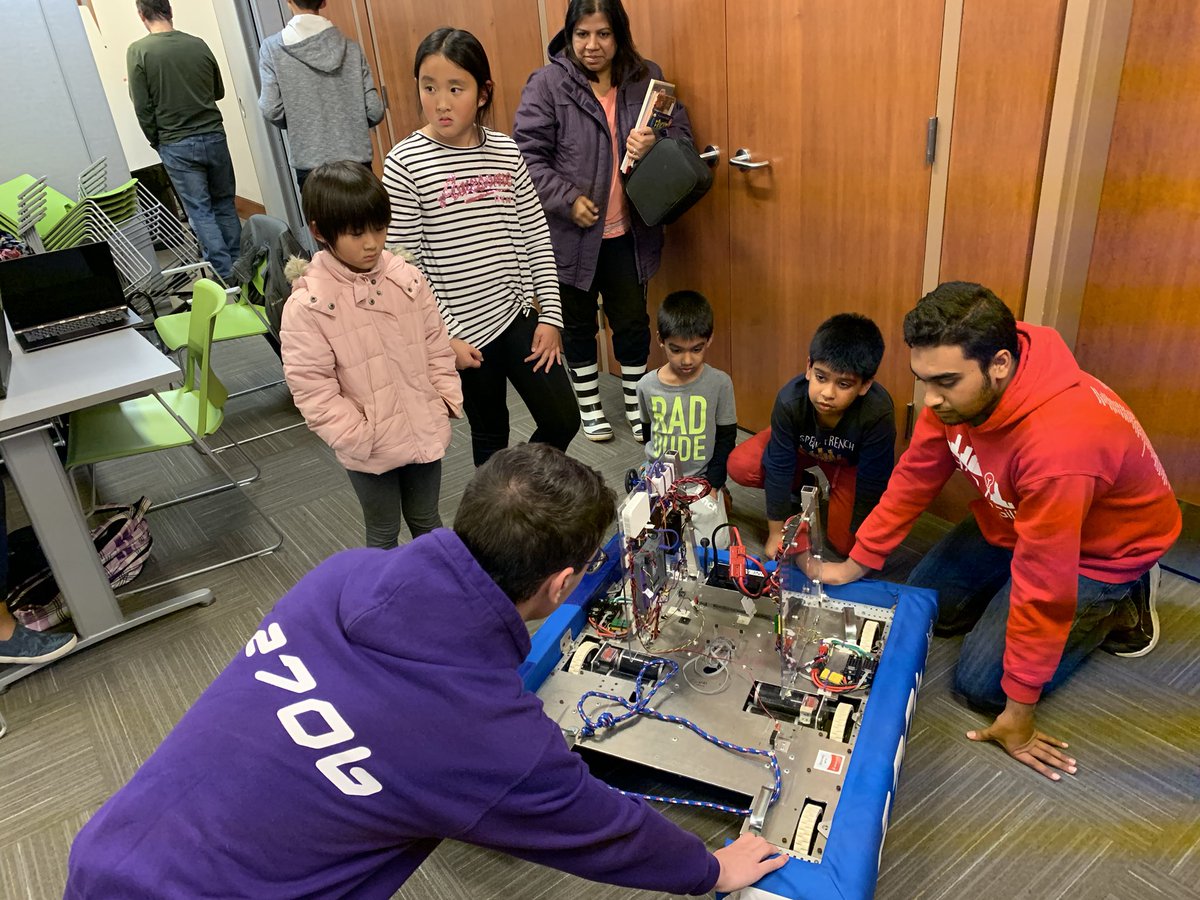 frc2706's tweet photo. Happy Halloween! For the #RobotsAttack challenge we dressed up @SafetyShep and our Stronghold robot Mergio - and held an impromptu outreach event to our library friends π https://t.co/k9fyYLazXC