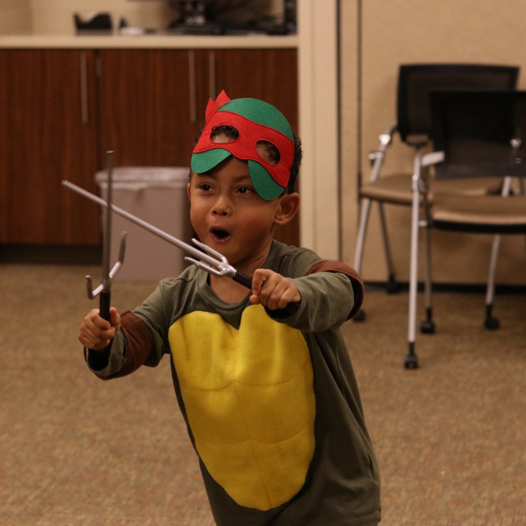 Happy Halloween from MizzouThon and your favorite teenage mutant ninja turtle! 🎃👻
.
.
.
[Image description: a boy in a turtle costume plays with his plastic swords]