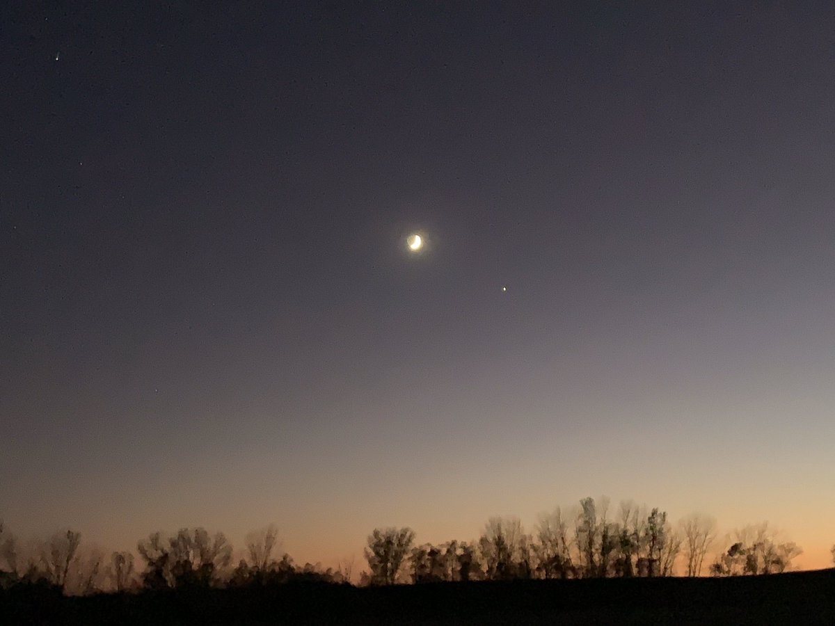 New moon over harvested cornfield