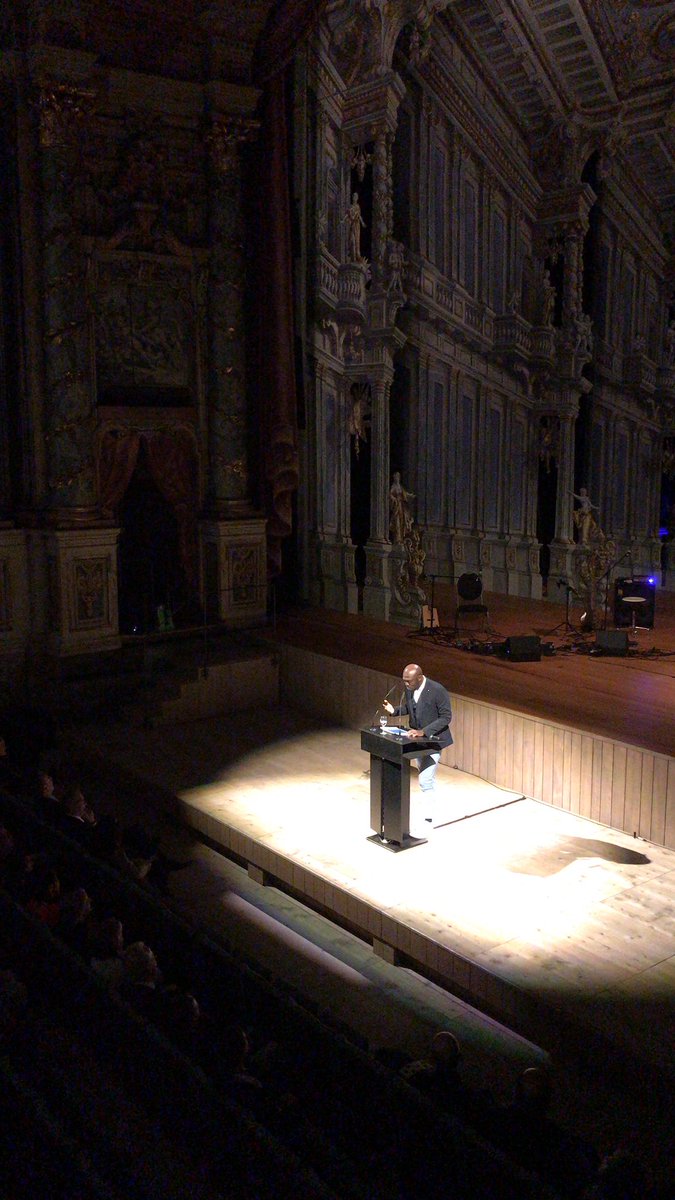 Elnathan John challenges in Bayreuth the silence in academia about not caring to answer what is humanities all about if humans are not free.