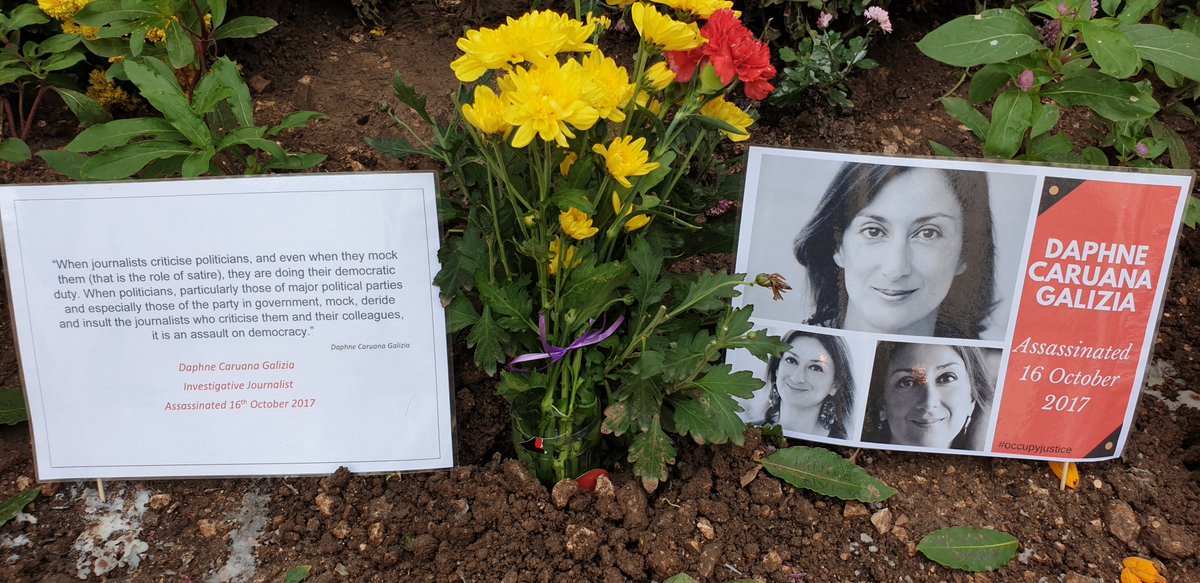 occupyjusticema's tweet photo. #MemorialWatch another day, another protest. OwenBonnici's latest statement is that the memorial is cleared every day to prevent damage to the monument. Please someone tell us how the posters & candles & flowers here can damage a monument. We're dying to know @RSF_inter @ECPMF https://t.co/zVGfSMF59z