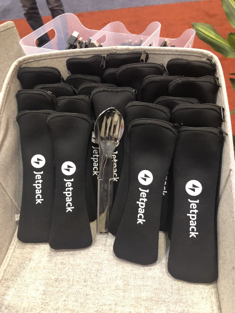 dimensionmedia's tweet photo. The @jetpack booth at @WordCampUS contains A useful charter swag, Nathan fork swag, and a talented cartoonist. You know, the basics. #WCUS https://t.co/y4q7qGux5N