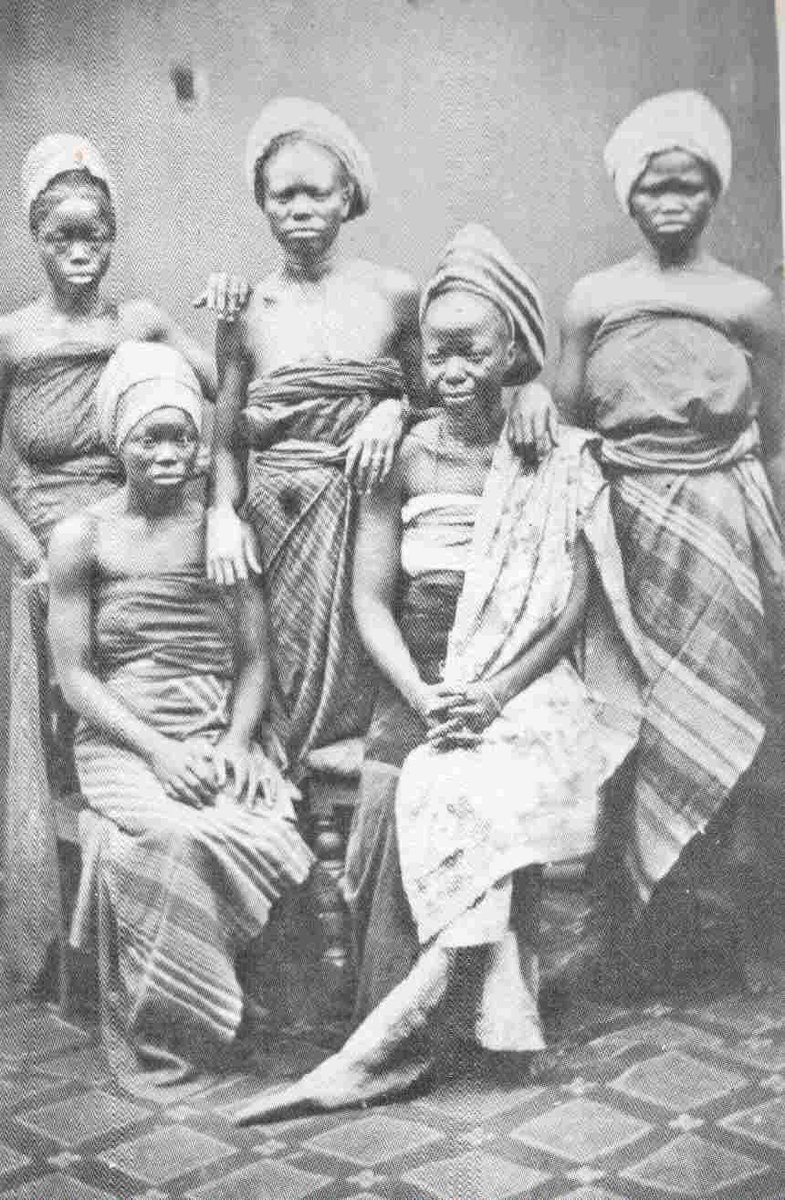A group portrait of Yoruba women in traditional clothes a "Adire". Late 1890s.