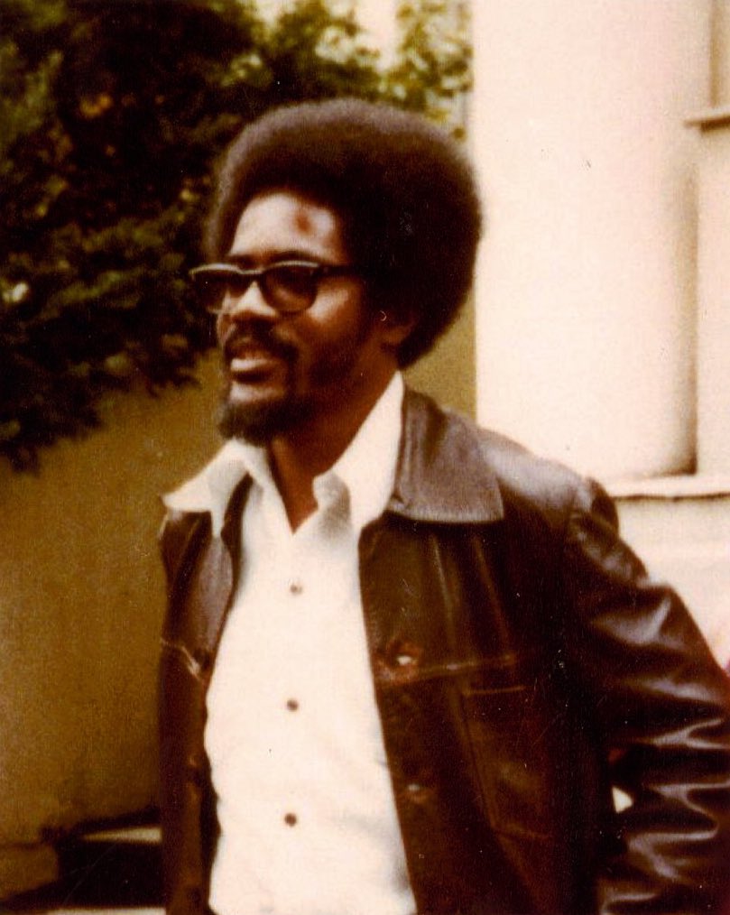 Walter Rodney standing with a subtle smile.