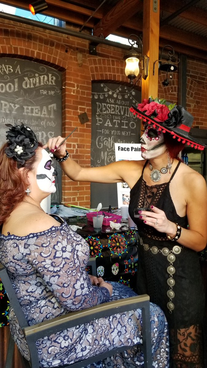 Getting ready for the procession is one of the best parts, says Jessica Johnson. She is here with her sister, Jennifer Johnson, doing makeup with Tipsy Picasso's, a paint party event company in Tucson. #AllSoulsProcession #AllSoulsTucson #UAJOUR506