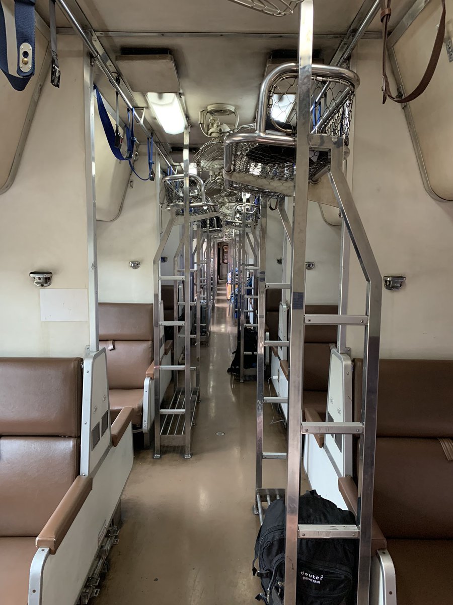 ADDENDUM: Interior of AC Sleeper, second class of State Railway of Thailand Special Express № SP38 from Sungai Kolok to Bangkok Hualamphong. The luggage racks along the way restrict free movement of people. Bad design. Cost of travel for 18 hrs – S$50 / €33 / US$33 / £28.