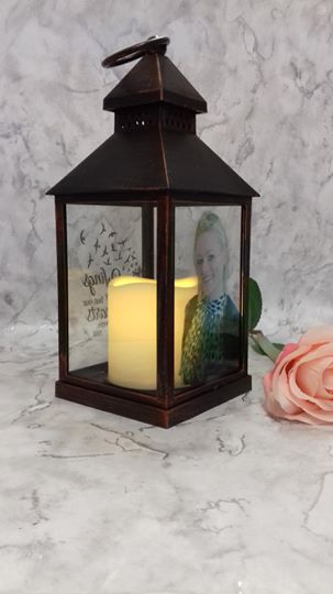 A Personalised Photo Lantern. Ideal for a Memorial on a loved ones grave.The images are directly applied to the glass with any photo you require. Lantern measures  23 X 10wide X 10cm deep and comes in either White or Bronze colour. The cost for the Lantern is only £75
