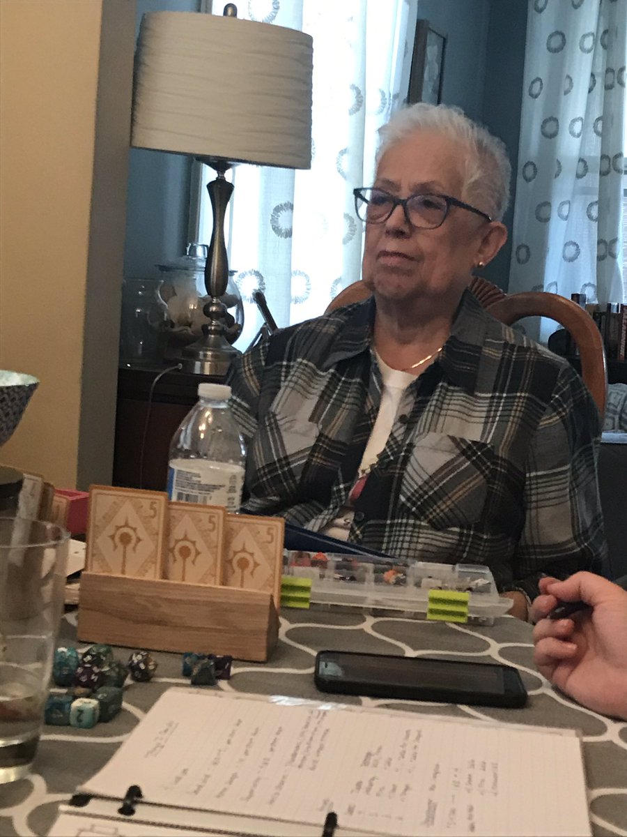 Photo 1 - Mom rocking her new folder for her character sheet/notes (thank you to Kevin from <a href="/DungeonDumplins/">Dungeon Dumplin’s</a> for the awesome decal!)

Photo 2 - My greatest reward as a story teller is looking up and seeing mom make this face during game.  So engaged and so happy.