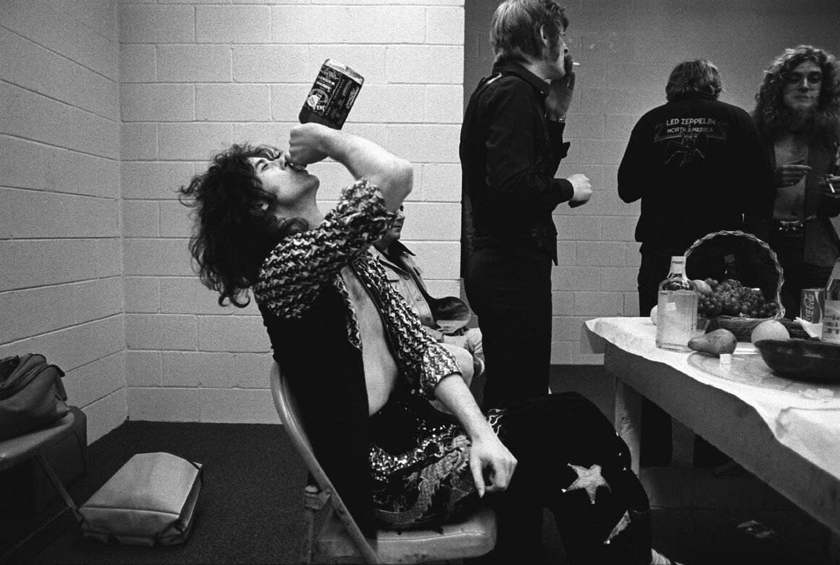 crockpics's tweet photo. Jimmy Page downing a bottle of jack before a concert, 1975. Photo by Neal Preston. https://t.co/ioGbPFi6l4
