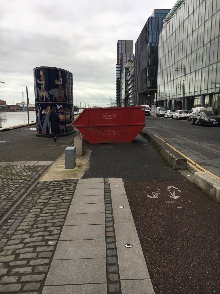 JosephPKilroy's tweet photo. This feels like peak disrespect for cyclists. Someone has placed a skip in the busy cycle lane in grand canal dock. @DCCTraffic @ccferrie @CiaranCuffe @IBIKEDublin @dublincycling @DublinCommuters https://t.co/hMnHRnzmwc