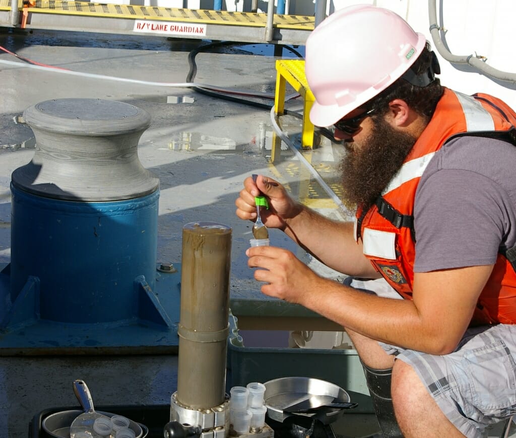 Researcher Ryan Lepak taking samples