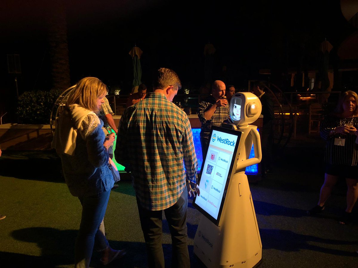 ARS_Robots's tweet photo. While the rest of us at ARS freeze in CT, Tracey the #robot is nice and warm in Florida at WestRock's Annual Meeting! Tracey had a scripted interaction with their speaker yesterday morning then spent the night at their cocktail hour. https://t.co/nYJzzRhpHR