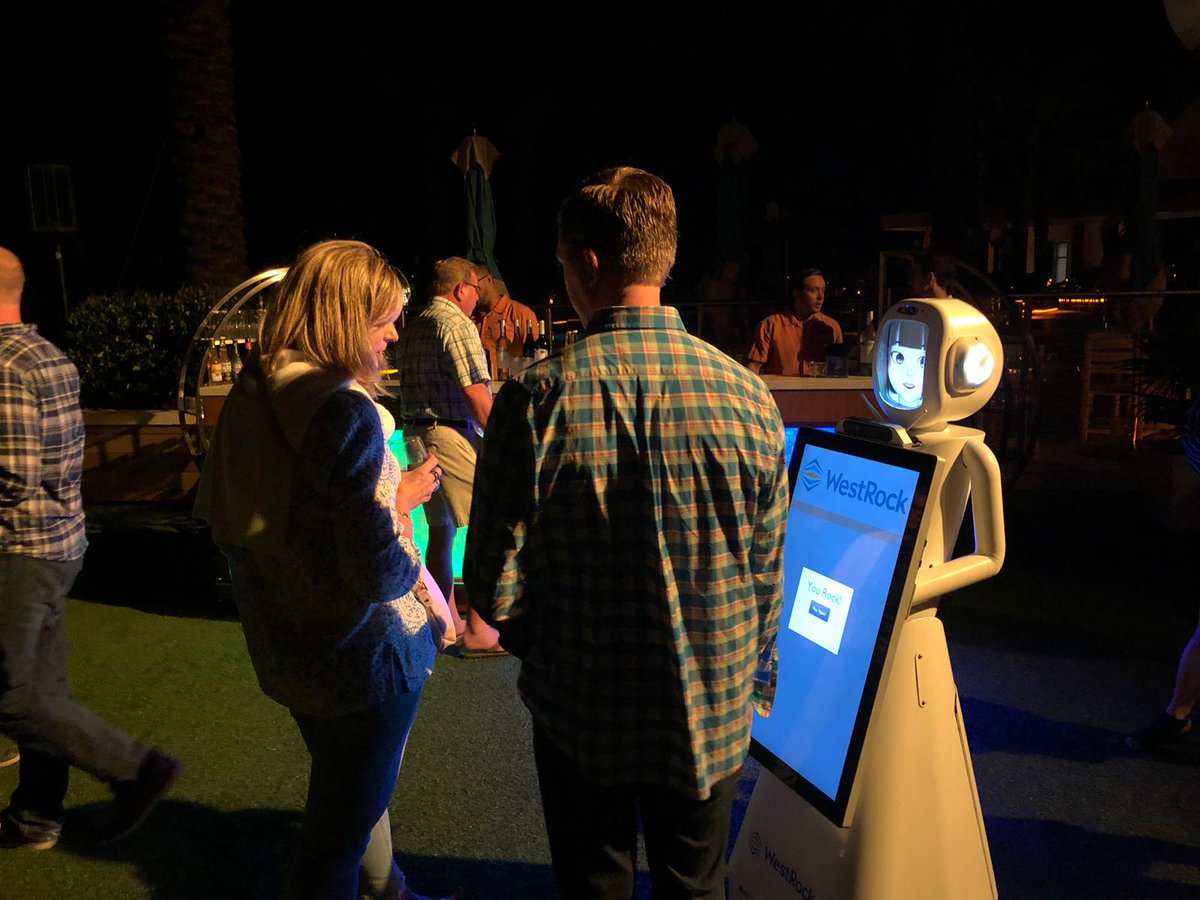 ARS_Robots's tweet photo. While the rest of us at ARS freeze in CT, Tracey the #robot is nice and warm in Florida at WestRock's Annual Meeting! Tracey had a scripted interaction with their speaker yesterday morning then spent the night at their cocktail hour. https://t.co/nYJzzRhpHR