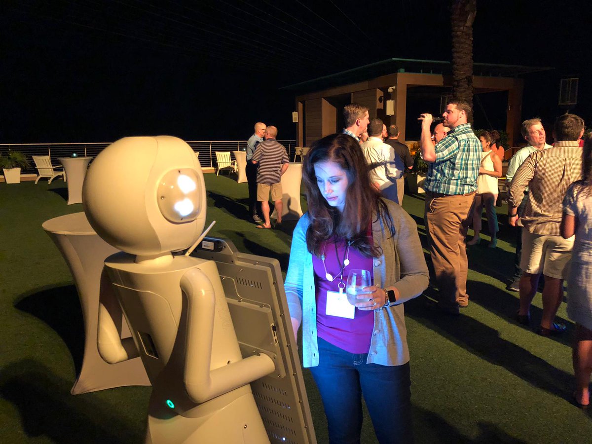 ARS_Robots's tweet photo. While the rest of us at ARS freeze in CT, Tracey the #robot is nice and warm in Florida at WestRock's Annual Meeting! Tracey had a scripted interaction with their speaker yesterday morning then spent the night at their cocktail hour. https://t.co/nYJzzRhpHR