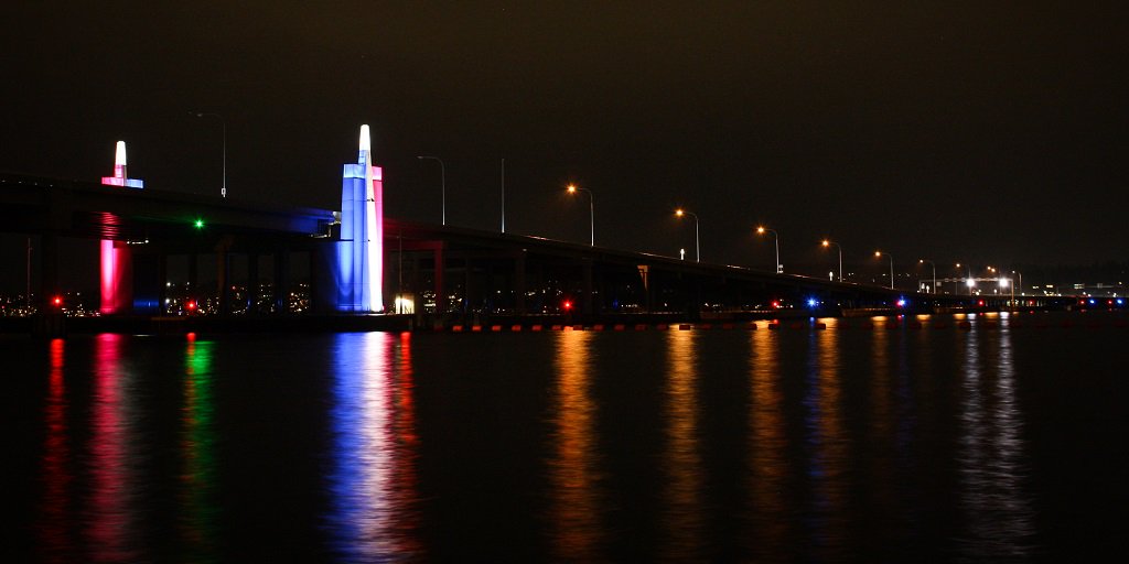 The 520 bridge sentinels shine red, white and blue at night