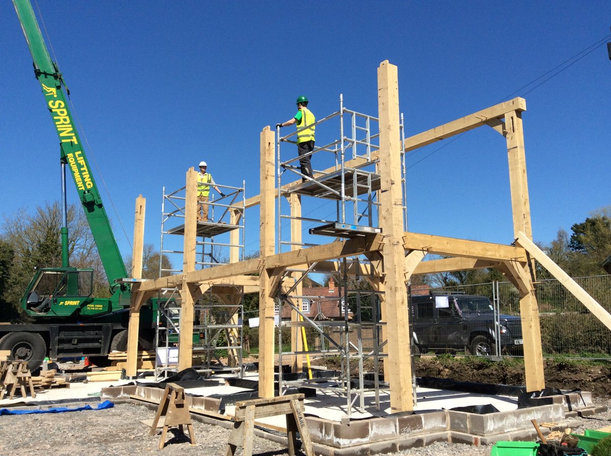 Timber frame traditionally uses mature trees sawn to give square lumber of predetermined sizes. It is good use of wood, but there's quite a bit of waste, the trees are heavy and needs machines or horses to transport, and today most building sites use heavy machinery to handle it.