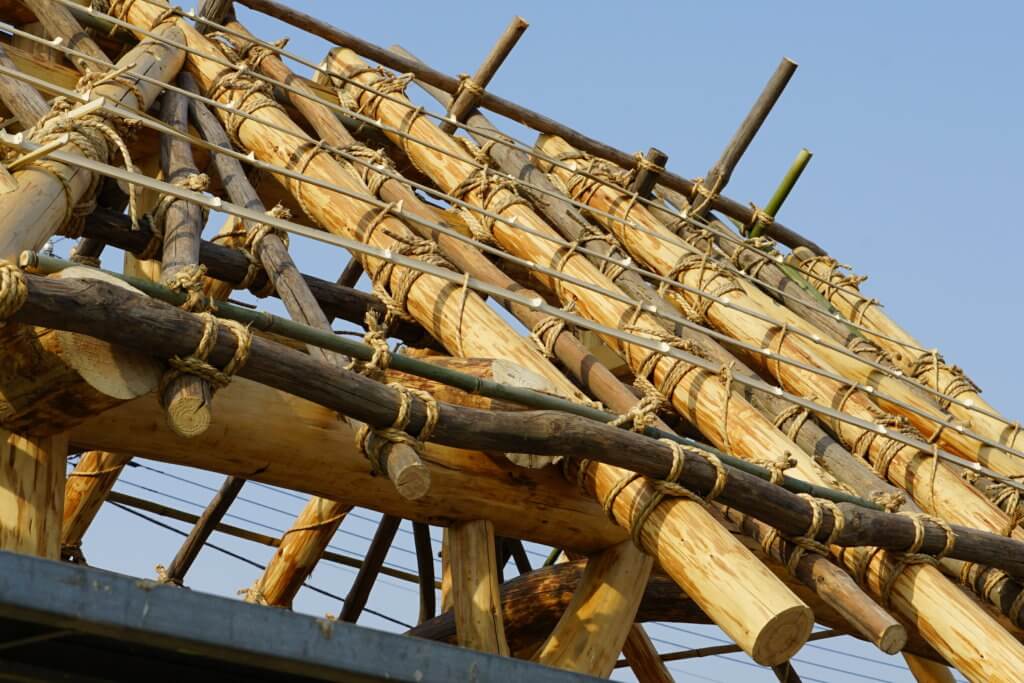 In Japan pole timber is still used for roofs and ceilings especially, and in a way that requires almost no skill, no cutting, no tools, no complicated joinery: just tie it up with hemp ropes. It will last centuries if kept dry.