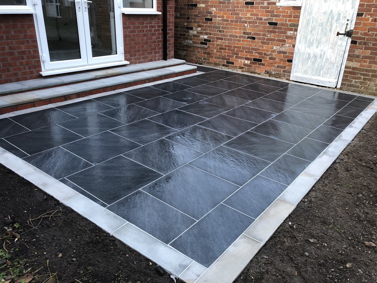 jdma_paving's tweet photo. Before and after photos of a new patio completed today in Bungay, Suffolk. @BradstoneUK mode profiled 6x6 porcelain in graphite with a light grey border and light grey bull nose steps #paving #bradstone #eastanglia #suffolk #jdma https://t.co/wuTXg13el6