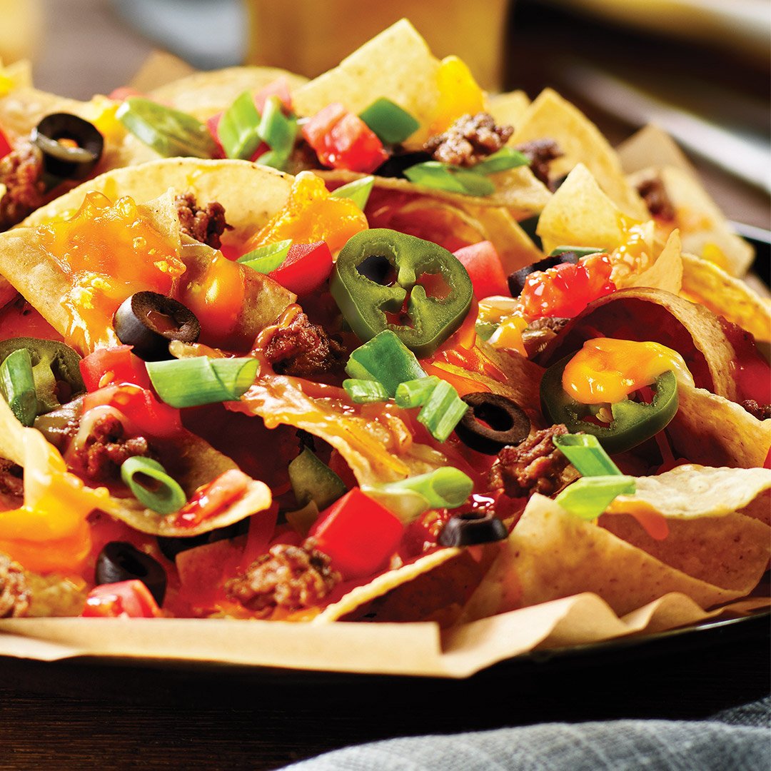 bostonpizza's tweet photo. We’re celebrating #NationalNachosDay with BP’s Classic Nachos! It’s nacho fault if you can’t resist these hand-cut tortilla chips topped with deliciousness. 😉 https://t.co/oyTN8XXVbA