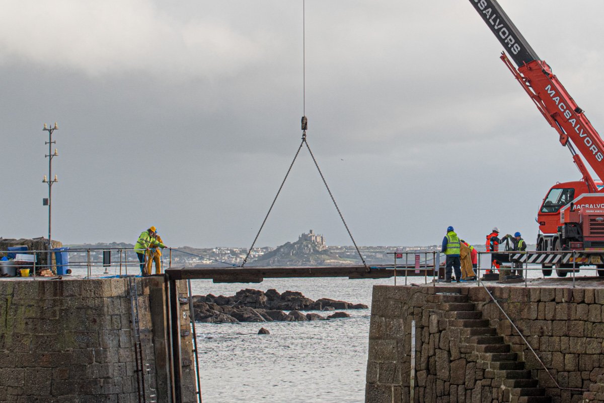 St Michaels Mount being lifted out of the water for winter storage this morning, by a giant crane at Mousehole, Cornwall.