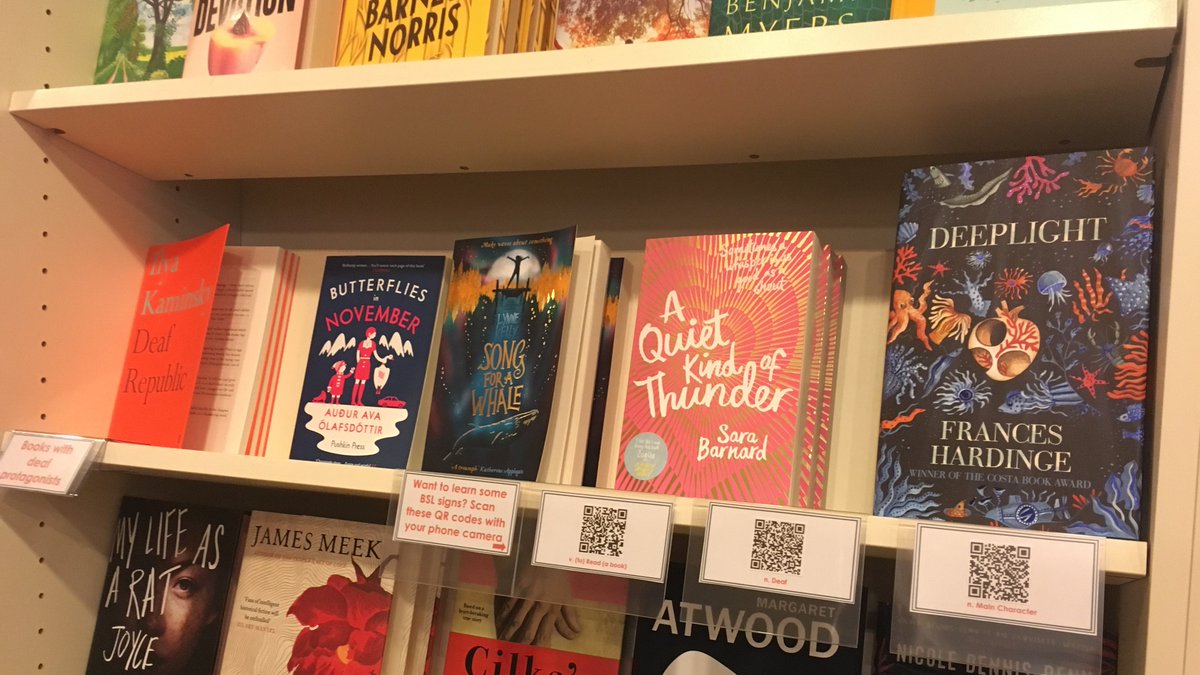 mrbsemporium's tweet photo. Have you seen our shelf of fantastic books with deaf characters? If you scan the QR codes with your phone camera you can learn the British Sign Language for 'read', 'deaf' and 'main character'. #diversitymatters #BSL @BAbooksellers https://t.co/BwBabqZpBd