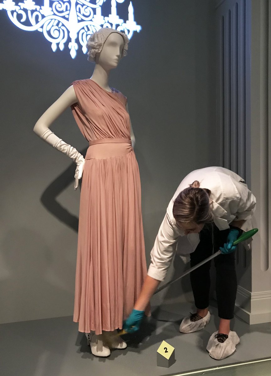 ChicagoMuseum's tweet photo. Today CHM collection tech Allison Pohl is cleaning in #SilverScreenChi. Wigs are dusted & platforms are swept. For the Stanley Korshak ostrich feather dress (1941), she uses a gentle-suction vacuum & holds a screen over the nozzle for extra protection. https://t.co/oQXRX0syIF https://t.co/Z5tzMGxEE7