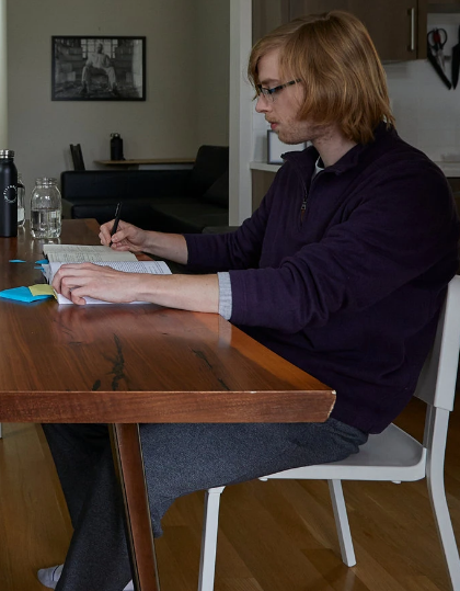 One of the tech bros reading a book and making notes, probably at home.