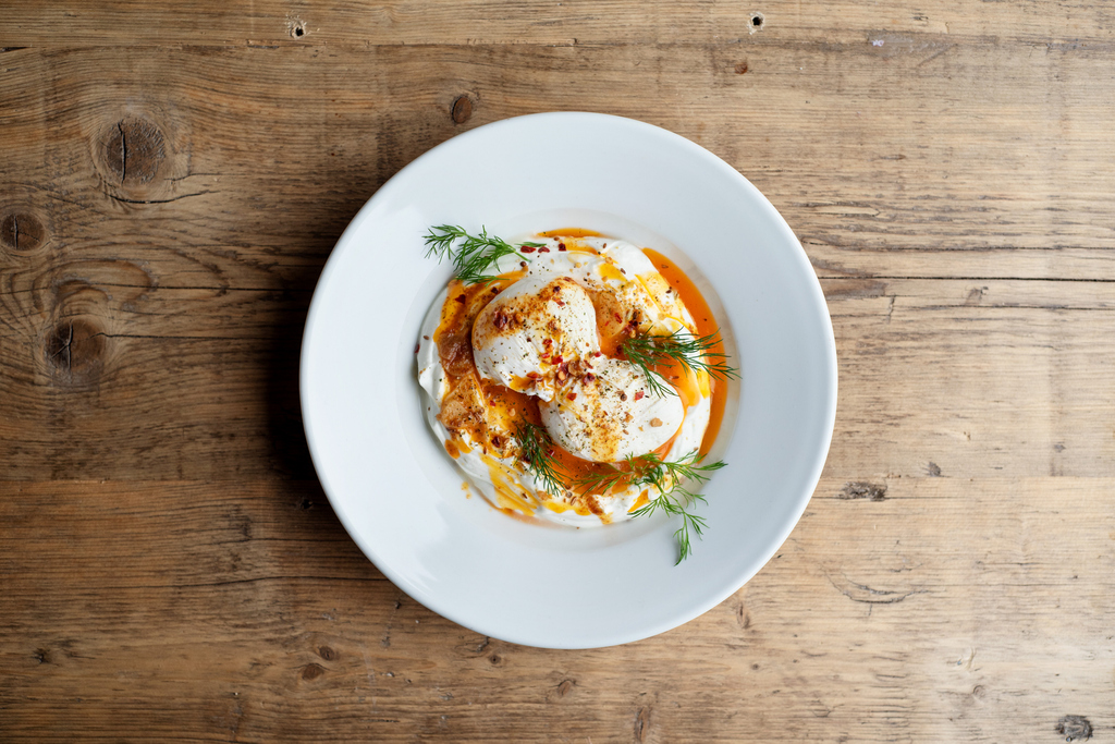 Our Turkish Eggs, but not as you know them. 2 poached eggs on Greek yoghurt topped with spiced butter, smoked paprika, garlic and dill. Served with two slices of freshly baked Sourdough, our new recipe is the perfect brunch dish.