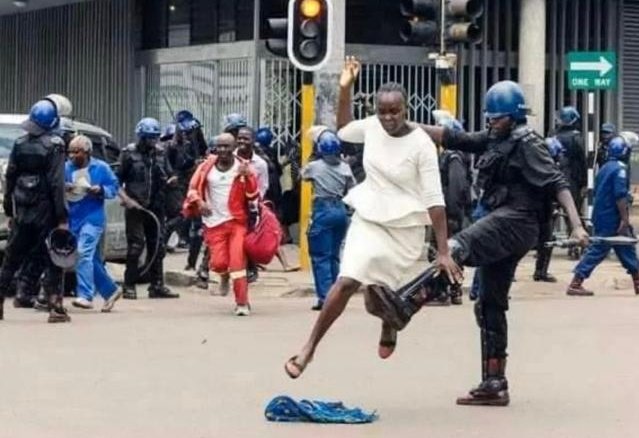 zimlive's tweet photo. #DevilCop The evil police officer seen tripping a woman after police descended on peaceful MDC supporters massed outside their headquarters in Harare on Wednesday has been named as Ndawanahama Mtambisi from Marimba Police Station @ZLHRLawyers (1/2) https://t.co/iLnNMYmdWq