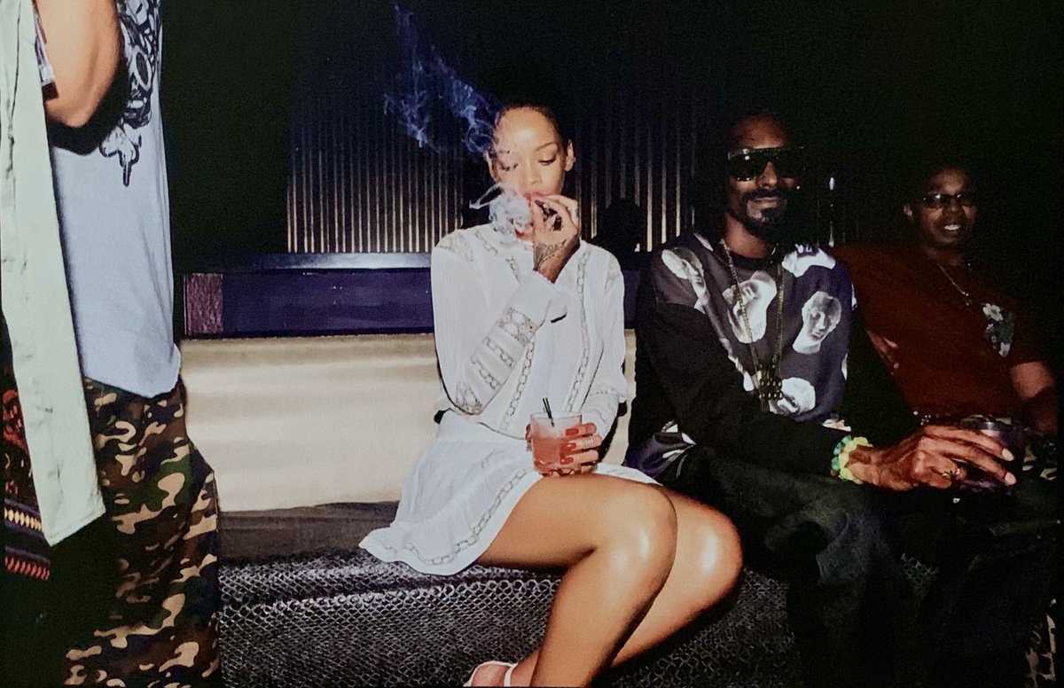 Rihanna smoking in the club with @SnoopDogg in Punta Cana, Dominican Republic. Photographed by Dennis Leupold (2013)