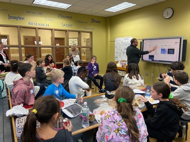 dateritc's tweet photo. Dater/Wandell Book Club get together to discuss Light on Hogback Hill and preparing for our annual visit to Brighton Gardens - Mr. Bogert helping us practice songs to sing and working hard on the craft to bring! Great interaction among the students. https://t.co/49x6V2TlE0