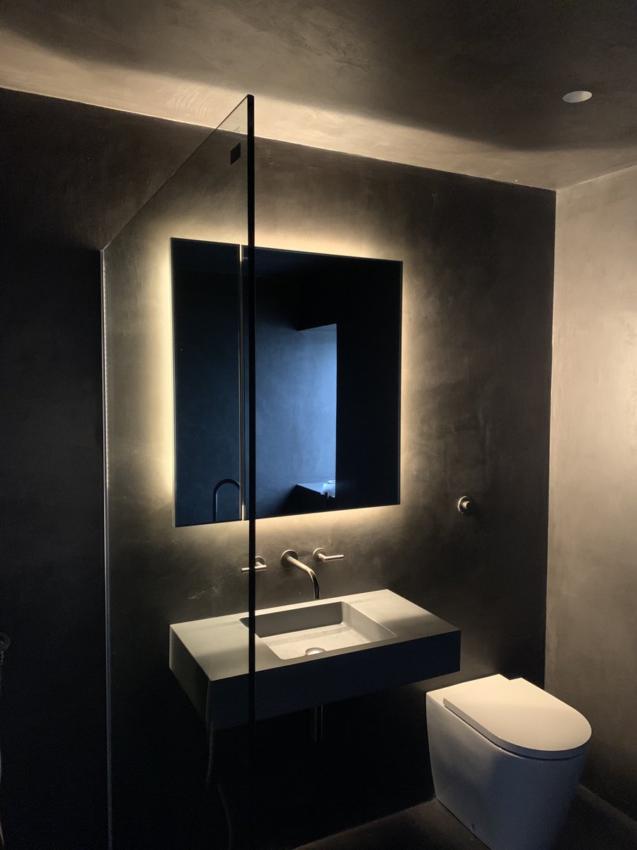 dynamic_surface's tweet image. All black bathroom. Lighting from wall cabinet really picks out the texture of the coating.