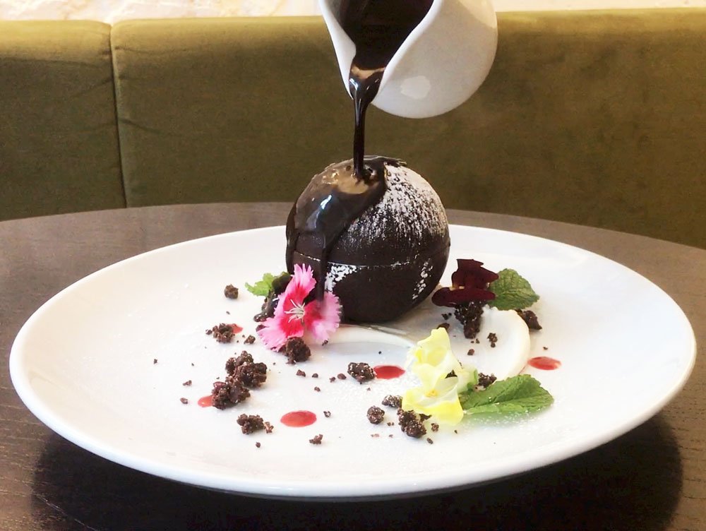 New #GlutenFree #vegan dessert on the menu: Dark Chocolate Snowball 🌱 Dark chocolate shell filled with #chocolate mousse, served with spiced orange coulis &amp; chocolate sauce
