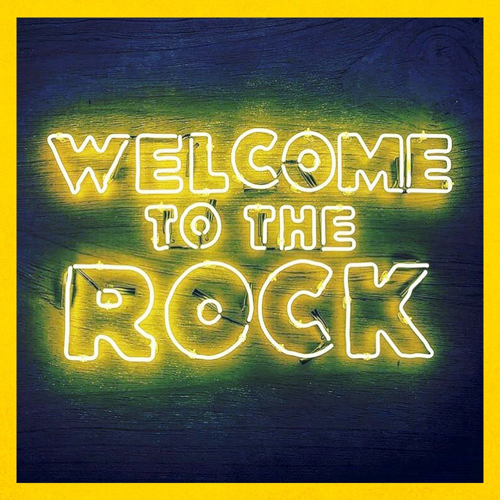 Neon sign that says WELCOME TO THE ROCK