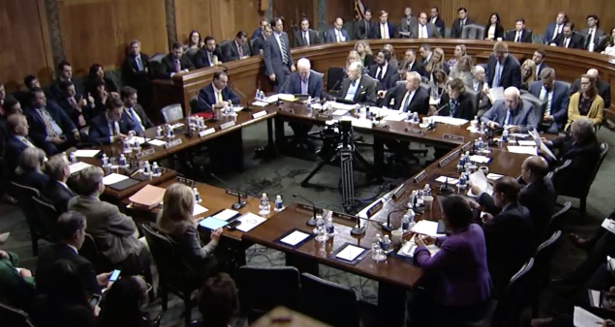 Screenshot of Judiciary Committee livestream shows senators sitting around a large table voting on judicial nominees.