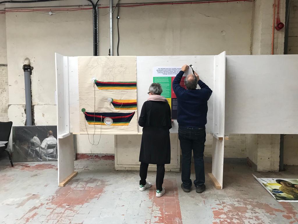 Solace_Research's tweet photo. The @Solace_Research  team has just set up the third (!) exhibition in 2019! Come and join us @StokingCurios 22/11 and  23/11. Spot the newest #WeAreSOLACE team members helping to set up: Andreas Dikomitis and Martine Vandevelde, f PI @LDikomitis parents! #gcrf #globalhealth https://t.co/PvQI7M8rzs