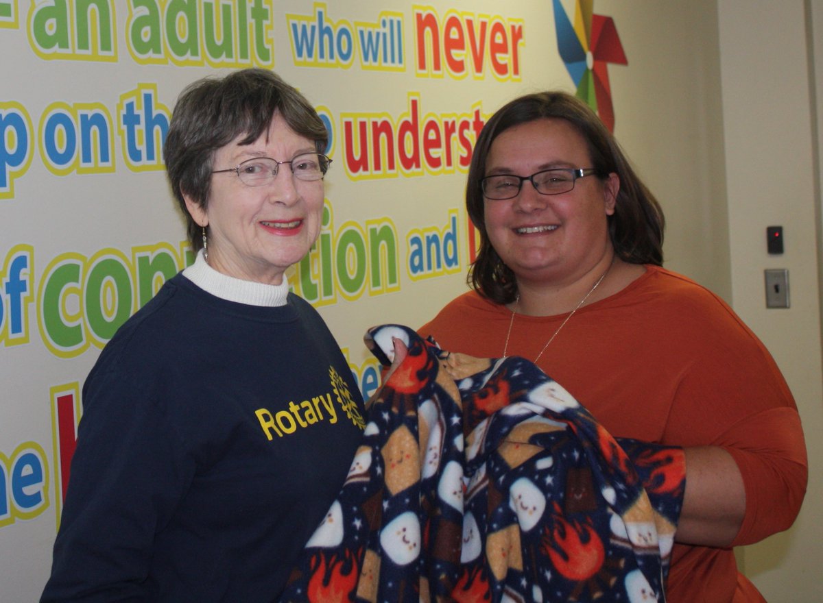Byesvile_Club's tweet photo. Elissa Mallett, Foster Care Coordinator, Guernsey County Children's Services, accepts 50 no-sew blankets from Rotarian Shana Fair. Blankets were made by members and friends of the Byesville Rotary and will be given to children taken into foster care. #6690 #ByesvilleRotary https://t.co/WErA99ePS1