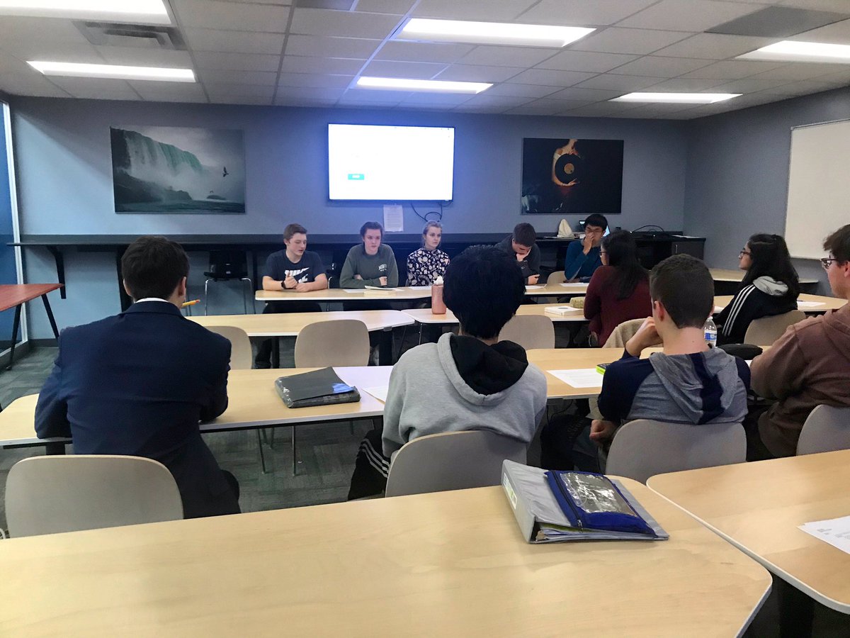 NNHSLC's tweet image. Mr. @gcschmit’s software engineering course engaged in spirited dialogue today in the glass classroom. Students were grappling with complicated questions about technology based on the books they read this semester. 🗣📚
#futurereadylibs #technology #ethicsintechnology #NNHSReads