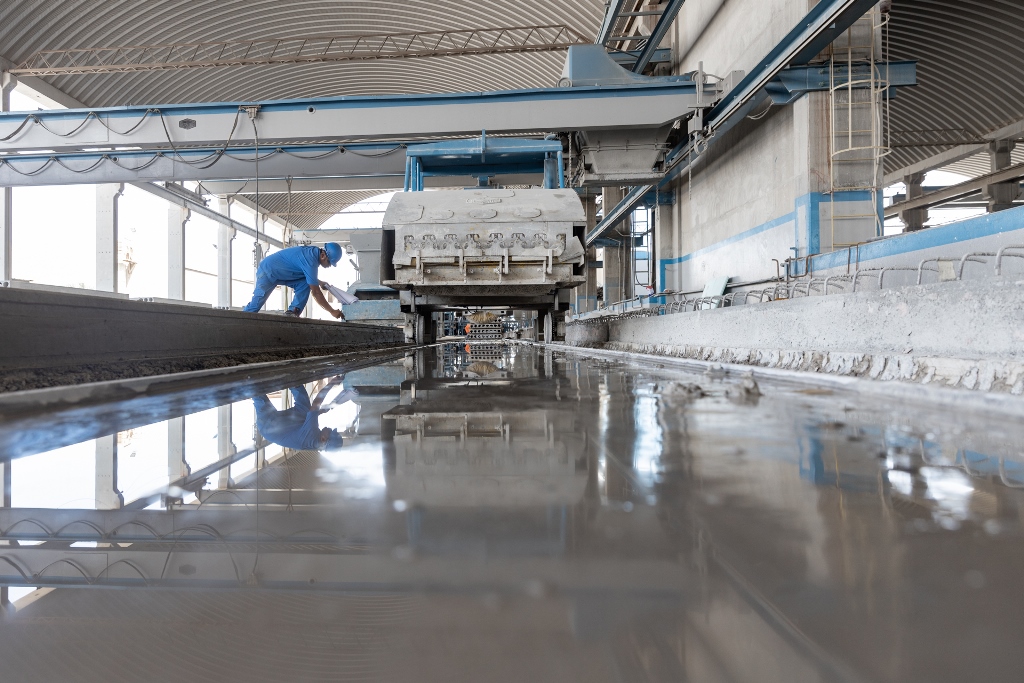 Elematic's tweet photo. Cleaning the casting bed after a completed hollow-core slab has been removed is a crucial step in #PrecastProduction. It ensures the quality of the next slab as there is nothing left on the bed that could make the surface uneven. #HowPrecastBuilds #PrecastProductionTechnology https://t.co/iTBcow7d8N